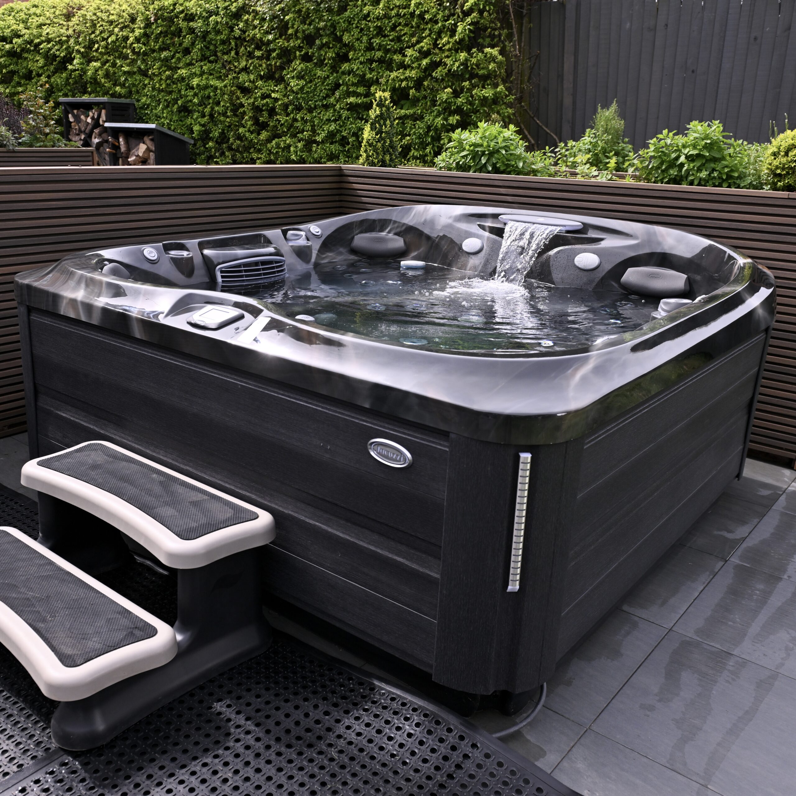 Jacuzzi® J-400 Hot Tub in a Lifestyle Setting Experience premium hydrotherapy in Northern Ireland with the Jacuzzi® J-400 Collection.