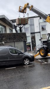 Coordinated lift placing Jacuzzi Lodge hot tubs onto balconies at Antrim House Portrush seafront.