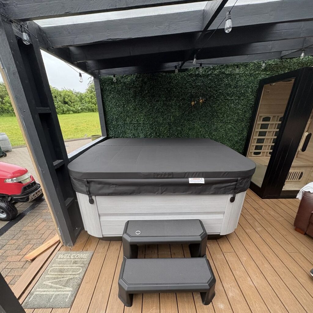 Jacuzzi® hot tub installation in a purpose-made garden wellness area in Belfast